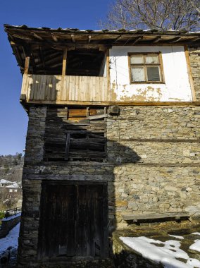 Bulgaristan 'ın Blagoevgrad Bölgesi, Otantik 19. yüzyıl evleriyle Kovaçevitsa Köyü Kış Günbatımı manzarası