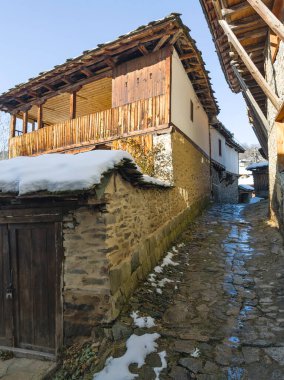 Winter Sunset view of Village of Kovachevitsa with Authentic nineteenth century houses, Blagoevgrad Region, Bulgaria clipart