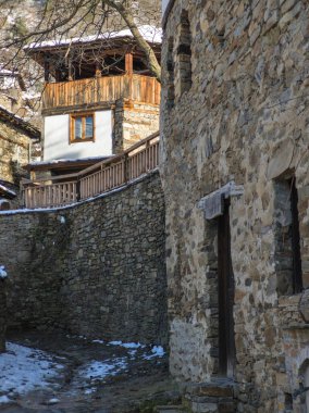 Winter Sunset view of Village of Kovachevitsa with Authentic nineteenth century houses, Blagoevgrad Region, Bulgaria clipart