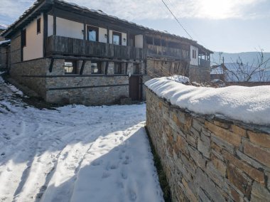 Bulgaristan 'ın Blagoevgrad Bölgesi, Otantik 19. yüzyıl evleriyle Kovaçevitsa Köyü Kış Günbatımı manzarası
