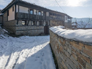 Winter Sunset view of Village of Kovachevitsa with Authentic nineteenth century houses, Blagoevgrad Region, Bulgaria clipart