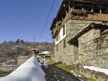 Bulgaristan 'ın Blagoevgrad Bölgesi, Otantik 19. yüzyıl evleriyle Kovaçevitsa Köyü Kış Günbatımı manzarası