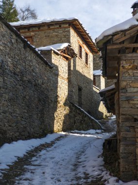 Bulgaristan 'ın Blagoevgrad Bölgesi, Otantik 19. yüzyıl evleriyle Kovaçevitsa Köyü' nün kış manzarası