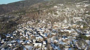 Bulgaristan 'ın Blagoevgrad Bölgesi, Otantik 19. yüzyıl evleriyle Kovaçevitsa Köyü' nün Hava Kış Günbatımı manzarası