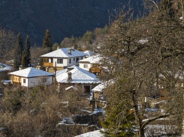 Bulgaristan 'ın Blagoevgrad Bölgesi, Otantik 19. yüzyıl evleriyle Kovaçevitsa Köyü' nün kış manzarası