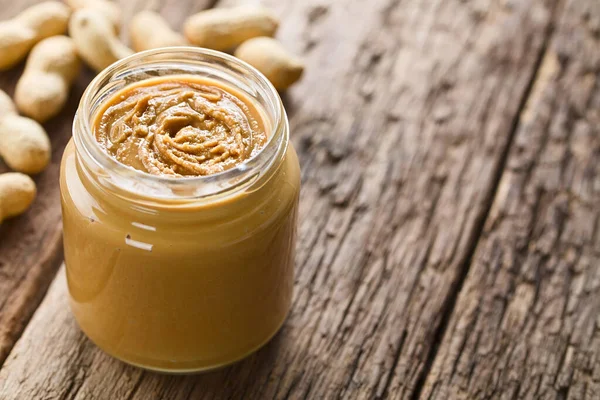 Creamy Smooth Peanut Butter Jar Peanuts Shell Back Photographed Wood — Stock Photo, Image