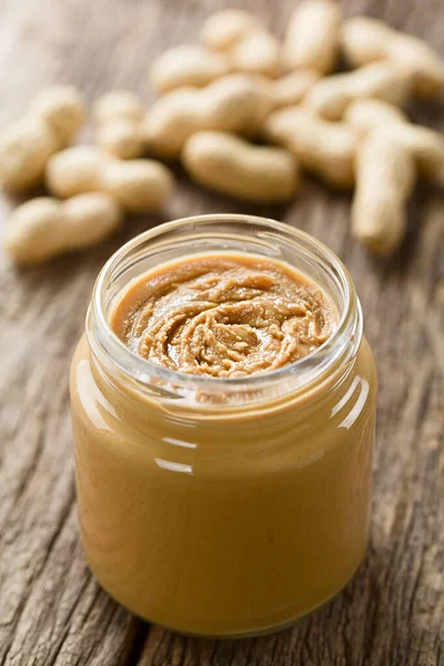 Creamy Smooth Peanut Butter Jar Peanuts Shell Back Photographed Wood — Stock Photo, Image