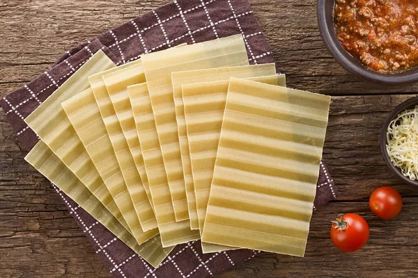 Dry Uncooked Ridged Lasagna Pasta Sheets Photographed Overhead Rustic Wood — Stock Photo, Image