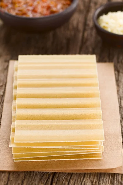 Dry Uncooked Ridged Lasagna Pasta Sheets Stacked Wooden Table Bolognese — Stock Photo, Image