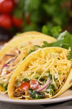 Taco with ground beef and avocado, cabbage and cheese. Mexican cuisine. Close-up. clipart