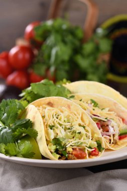 Taco with ground beef and avocado, cabbage and cheese. Mexican cuisine. Close-up. clipart