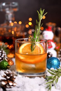 Bourbon Old Fashioned Kış Kokteyli. Sıcak burbon, taze limon ve portakalla karıştırılmış baharatlı biberiye şurubu.