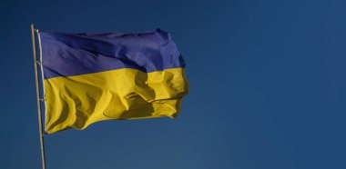 Ukrainian waving flag as a national symbol in struggle for independence, freedom and sovereignty.