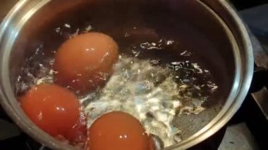 Chicken eggs boil in a saucepan. Cooking eggs.