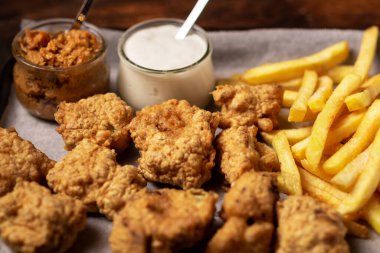 Cauliflower wings food. Cauliflower pieces and french fries with vegan sauces. Vegetarian food.