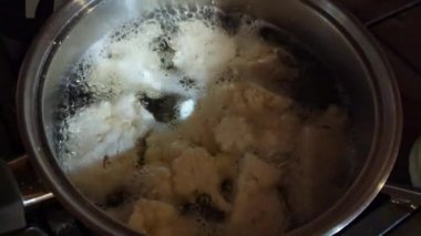 Boil cauliflower in water in a saucepan. Preparing to cook cauliflower on the grill.