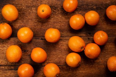 Oranges on a wooden background. Lots of citrus fruits lie. Fruit background. Diet on oranges concept.