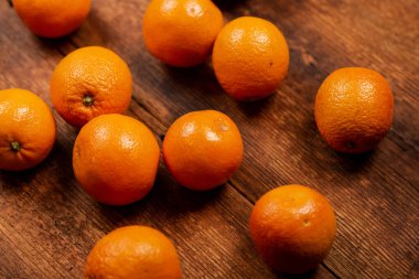 Oranges on a wooden background. Lots of citrus fruits lie. Fruit background. Diet on oranges concept.