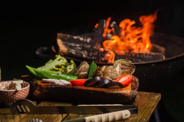 Various vegetables - artichokes, peppers, kohlrabi, tomato - prepared for grilling. Vegan food, healthy food. Green grilling.