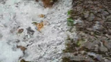 Stormy water flow of a stream close-up.