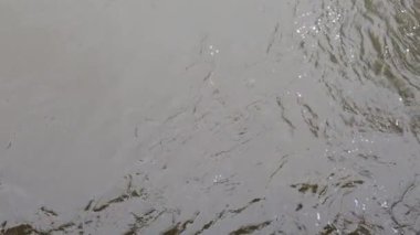 Surface of moving opaque dirty water. Water body pollution, environmental disaster concept.