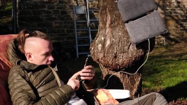 Portable Solar Battery Tree Man Texting Phone Relaxing Garden House — Stok video