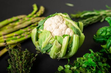 Karnabahar ve çeşitli sebzeler. Sağlıklı, vejetaryen yiyecekler. Koyu arkaplan.