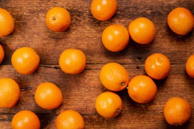 Oranges on a wooden background. Lots of citrus fruits lie. Fruit background. Diet on oranges concept.