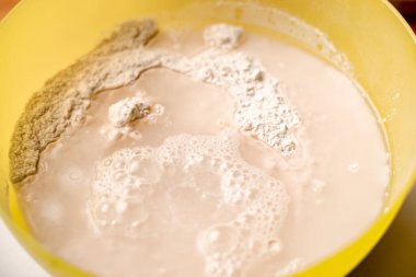 Un, kuru maya ve suyu karıştırıyorum. Ekmek ya da pizza için hamur pişiriyorum..