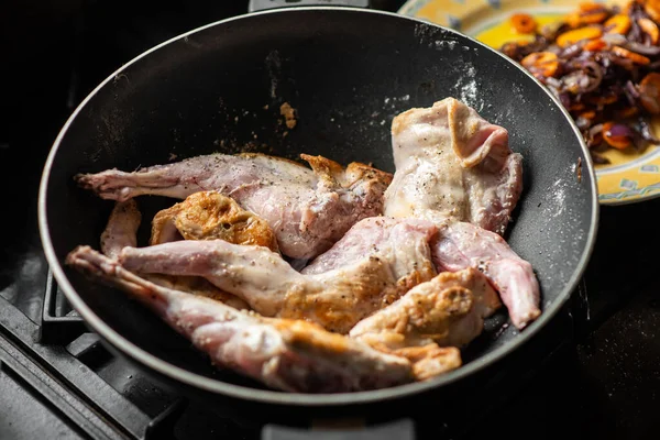 stock image Raw rabbit with spices in a pan. Cooking stewed rabbit.