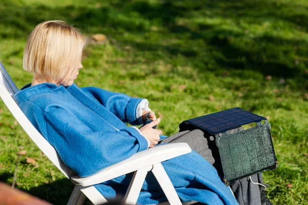 Woman Coat Mobile Phone Her Hands Portable Solar Battery Sits — Fotografia de Stock