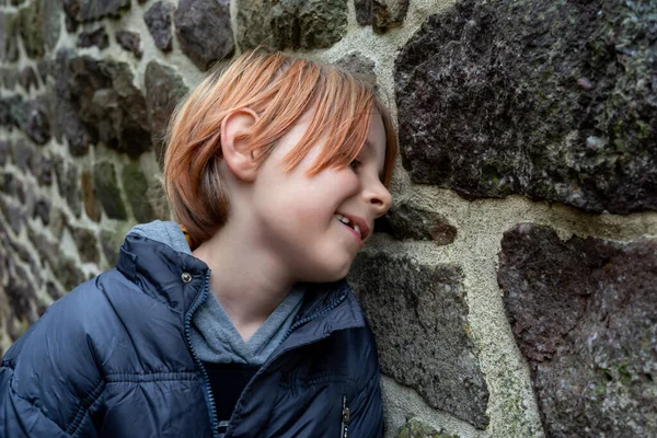 Smiling Contented Boy Stone Wall Boy Nine Ten Years Age — Foto de Stock
