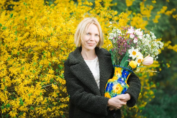 Žena Středního Věku Zeleném Kabátě Kyticí Různých Květin Pozadí Kvetoucích — Stock fotografie