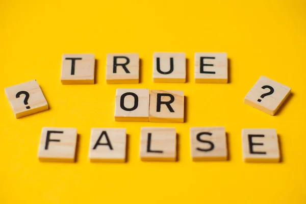True or false words on a yellow background with a question mark. Choice concept.