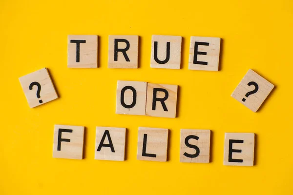True or false words on a yellow background with a question mark. Choice concept.