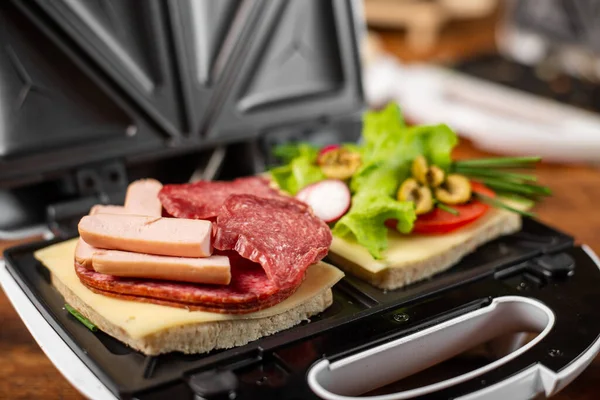 stock image Vegetarian and meat-eating sandwich. Comparison. Sandwich stuffed with meat sausages and ham against a stuffing of lettuce, onion, olives and tomato.