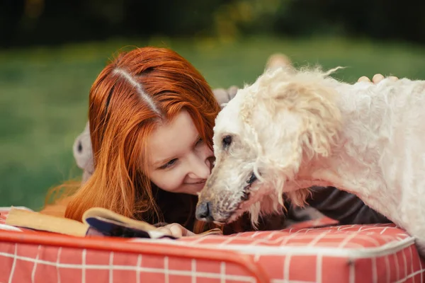 Girl Red Hair Lies Dog Smiles Recreation Outdoors Reading Book — Stock Photo, Image
