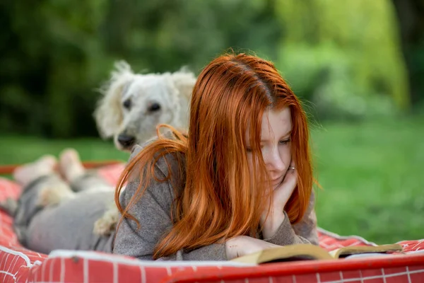 Red Haired Girl Reads Book Park Dog Green Plant Environment — Stock Photo, Image
