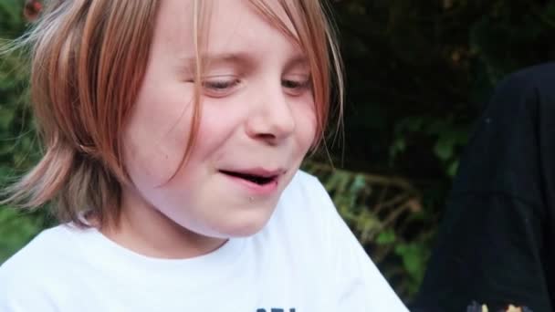 Jeune Garçon Sourit Mange Dehors Garçon Aux Longs Cheveux Roux — Video