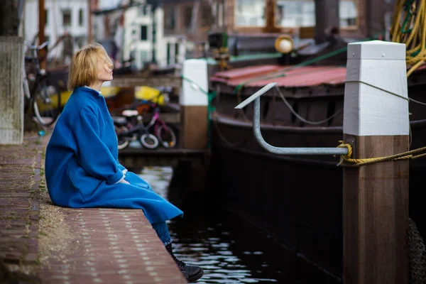 Šťastná Spokojená Dospělá Žena Stylovém Modrém Kabátě Sedí Molu Obytná — Stock fotografie