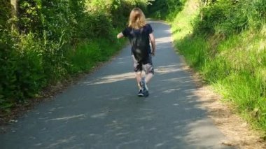 Genç bir insan temiz havanın ve güneşin tadını çıkararak kırsalda koşuyor..