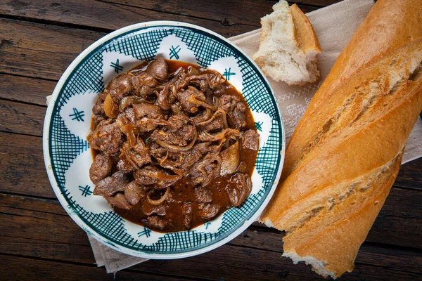 Chicken liver with onions with breath on the table