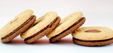 Chocolate sandwich cookies, baked biscuits stuffed with cocoa cream .