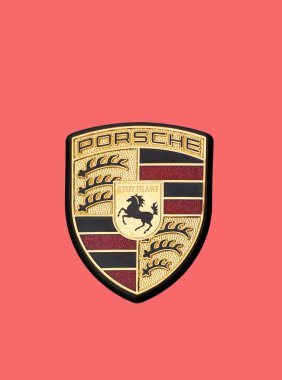Ptolemaida,Greece - january 18, 2023: Emblem of Porshe car isolated on pink. Porsche is German brand manufacturer of sports cars and luxury cars, founded in 1931 by Ferdinand Porsche