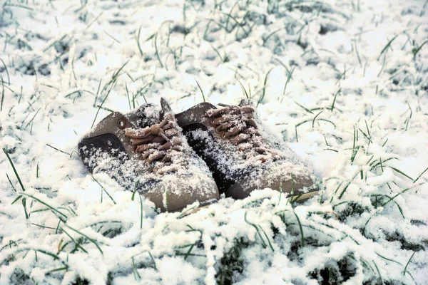 old used shoes in the snow. Winter theme