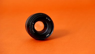 RESEN, MACEDONIA. FEBRUARY 20, 2023-vintage film lens on orange background, Jupiter-8 50mm f2 lens.