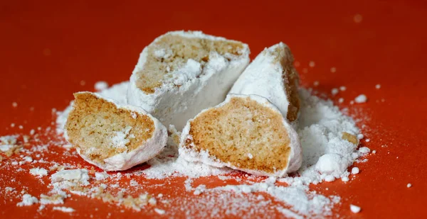 vanilla cookies crackers with sugar powder on orange background, sweet food theme.