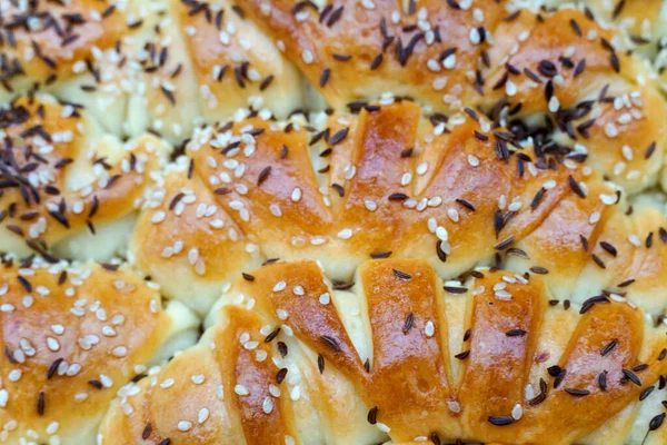 Homemade traditional fresh baked rolls with black caraway and sesame seeds.