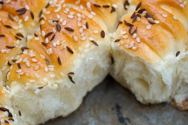 Homemade traditional fresh baked rolls with black caraway and sesame seeds.