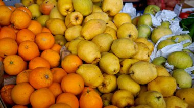 Fruit market with various colorful fresh fruits.